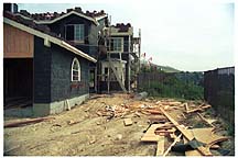 A house that is being built on the side of a hill.