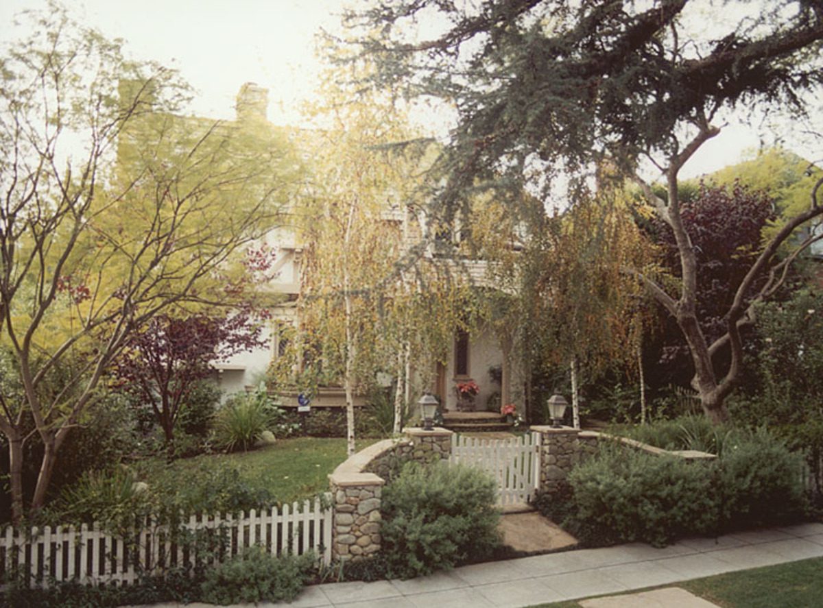 A house with trees and bushes in the yard