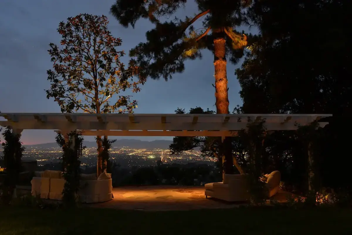 A view of trees and a gazebo at night.