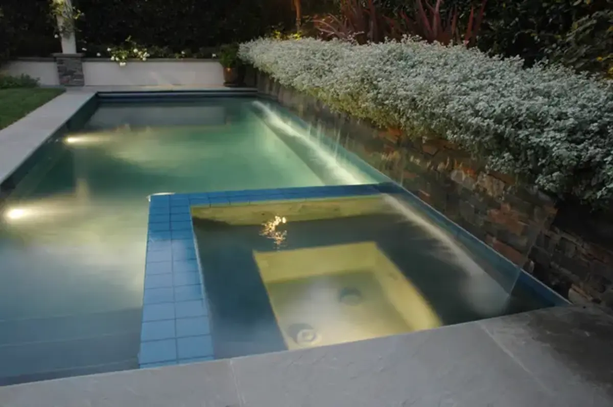 A pool with a light reflecting off the water.