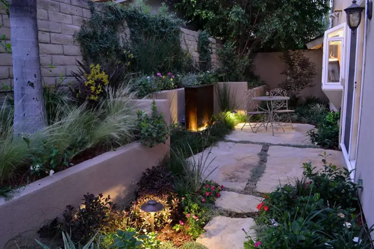 A garden with a fire pit and plants