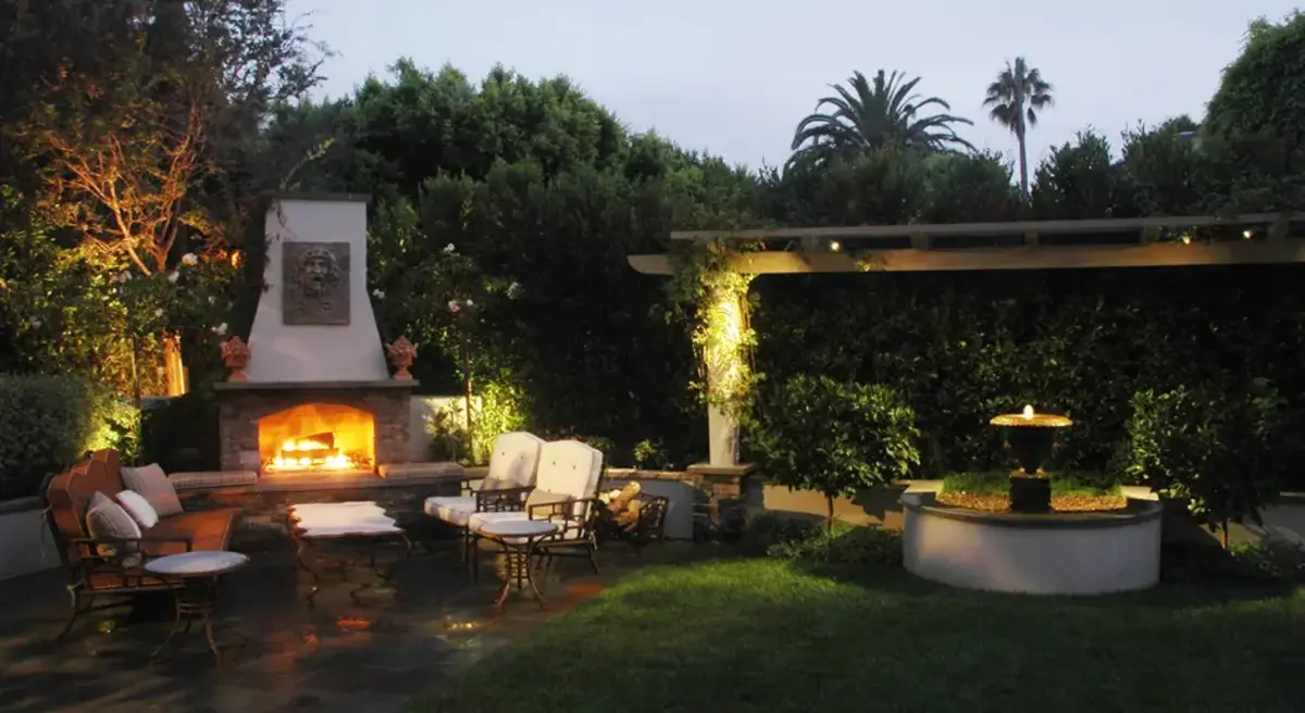 A patio with chairs and a fire place